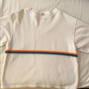A white sweatshirt with a rainbow in the middle.